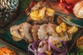 The slices of roulade of duck breast stuffed with braised Mandarin oranges with lettuce. Christmas dishes of the peoples of the