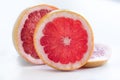 Slices of Ruby Grapefruit on white background Royalty Free Stock Photo