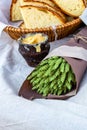 Slices of rustic bread wicker basket on white tablecloth bouquet of ears of green craft paper Royalty Free Stock Photo