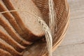 Slices of rye bread and ears of corn in basket Royalty Free Stock Photo