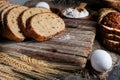 slices of rye bread, ears of wheat, eggs and a bowl of flour. Close-up Royalty Free Stock Photo