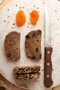 Slices of rye bread over on white round wooden board