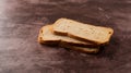 Slices of rye melba toast on a maroon background