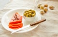 Slices of Salted Raw fish fillet with olive, quail eggs on white plate. Selection of good fat sources - healthy eating concept.