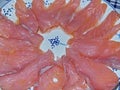 Slices of salted salmon on the holiday table. Natural food, appetizer. Gorgeous home appetizer under a glass of vodka.