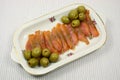 Slices of a smoked humpback salmon with olives Royalty Free Stock Photo