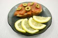 Slices of a smoked humpback salmon with olives and a lemon Royalty Free Stock Photo