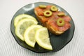 Slices of a smoked humpback salmon with olives and a lemon Royalty Free Stock Photo