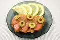 Slices of a smoked humpback salmon with olives and a lemon Royalty Free Stock Photo
