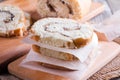 Slices of sweet cream roll with parchment paper on a cutting board Royalty Free Stock Photo