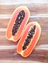 Slices of sweet papaya on wooden background Royalty Free Stock Photo