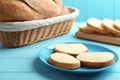 Slices of tasty fresh bread with butter on light blue Royalty Free Stock Photo