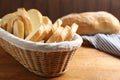 Slices of tasty fresh bread in wicker basket on wooden table Royalty Free Stock Photo