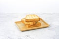 Slices toast bread in wooden dish on table. Royalty Free Stock Photo