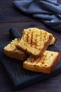 Slices toast wheat bread on a dark wooden background. Copy space. Royalty Free Stock Photo