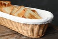 Slices of toasted bread in basket on wooden table Royalty Free Stock Photo