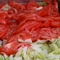 Slices of tomato and lettuce for sandwich, burger and salad fixings Royalty Free Stock Photo