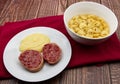 Slices of traditional Italian sausages Zampone di Modena with mashed potatoes and a Tortellini pasta dish Royalty Free Stock Photo