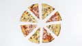 Slices of two types of pizza fn the shape of a circle on a white background Royalty Free Stock Photo