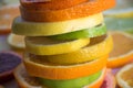 Slices of various citrus types arranged in a colorful stack