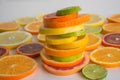 Slices of various citrus types arranged in a colorful stack