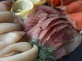 Slices of various salted fish - salmon, muksun, oily fish background