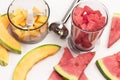 Slices of watermelon and melon. Pieces of melon and watermelon in blender jar. Metal blender Royalty Free Stock Photo