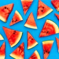 Slices of a watermelon triangular in shape on a blue background. Summer time concept Royalty Free Stock Photo