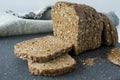 Slices of whole grain brown bread with sunflower seed, on a grey cutting board Royalty Free Stock Photo