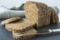 Slices of whole grain brown bread with sunflower seed, on a grey cutting board Royalty Free Stock Photo