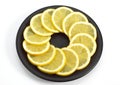 SLICES OF YELLOW LEMON citrus aurantifolia ON PLATE Royalty Free Stock Photo