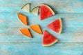 Slices of yummy fresh melon and watermelon on wooden background Royalty Free Stock Photo