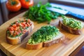 slicing an avocado next to a bruschetta toast on a wooden table