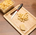 Slicing cheese with a knife on the board Royalty Free Stock Photo