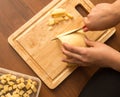 Slicing cheese with a knife on the board Royalty Free Stock Photo