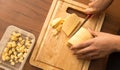 Slicing cheese with a knife on the board Royalty Free Stock Photo