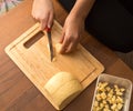 Slicing cheese with a knife on the board Royalty Free Stock Photo