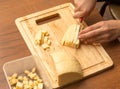 Slicing cheese with a knife on the board Royalty Free Stock Photo