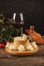 Slicing cheese on wooden board Royalty Free Stock Photo