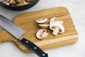 Slicing Cremini Mushrooms on a Wood Cutting Board Royalty Free Stock Photo