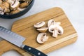 Slicing Cremini Mushrooms on a Wood Cutting Board Royalty Free Stock Photo