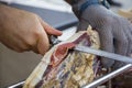 Slicing dry-cured ham prosciutto Royalty Free Stock Photo