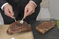 Slicing an entrecote on a carving table Royalty Free Stock Photo