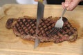 Slicing an entrecote on a carving table Royalty Free Stock Photo