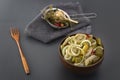 Slicing fermented green tomatoes and cucumbers with onions pickled garlic in a wooden bowl Royalty Free Stock Photo