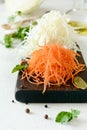 Slicing Fresh cabbage and carrots on a wooden board on a light background. Vegetables for ferment, for long fermentation. Royalty Free Stock Photo