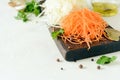 Slicing Fresh cabbage and carrots on a wooden board on a light background. Vegetables for ferment, for long fermentation. Royalty Free Stock Photo