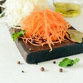 Slicing Fresh cabbage and carrots on a wooden board on a light background. Vegetables for ferment, for long fermentation. Royalty Free Stock Photo