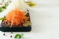 Slicing Fresh cabbage and carrots on a wooden board on a light background. Vegetables for ferment, for long fermentation. Royalty Free Stock Photo