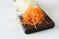 Slicing Fresh cabbage and carrots on a wooden board on a light background. Vegetables for ferment, for long fermentation. Royalty Free Stock Photo